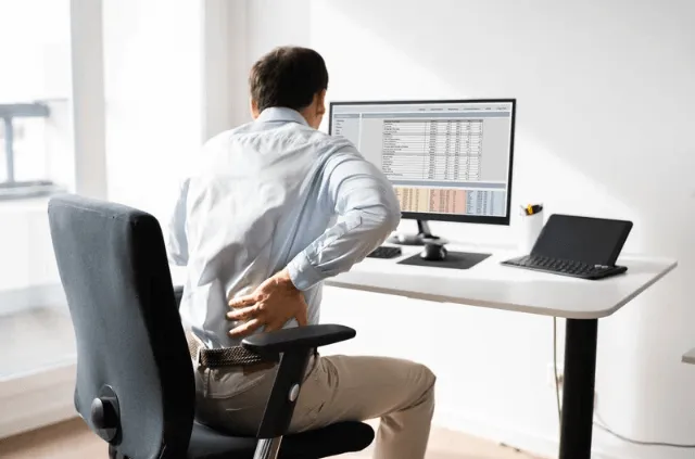 Office worker taking a standing break near desk